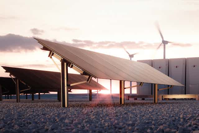 Solar panels, wind turbines and batteries in a photo illustration