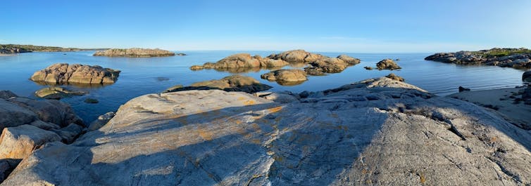 Rocks broken up on the edge of a body of water