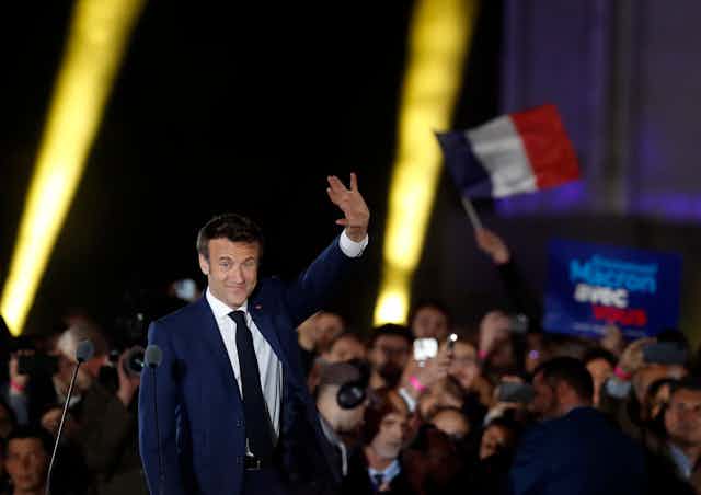Emmanuel Macron waves to supporters.