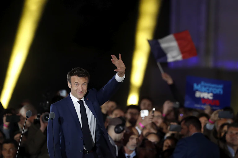 Emmanuel Macron waves to supporters.