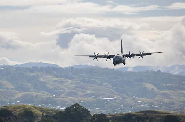 Royal Australian Air Force C-130 Hercules aircraft, preparing to land at Honiara International Airport, Solomon Islands