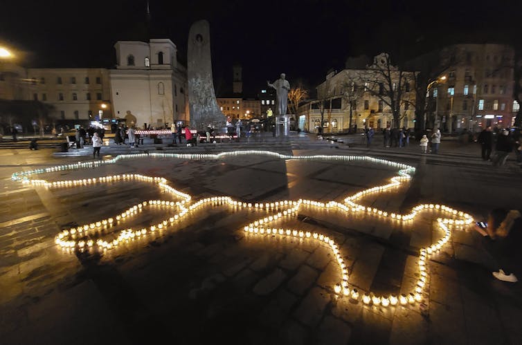 Ukrainians light candles in form of Ukrainian map on the central square of Western Ukrainian city of Lviv, 05 April 2022.