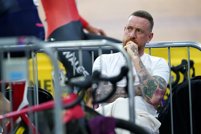 Man sat down surrounded by bikes