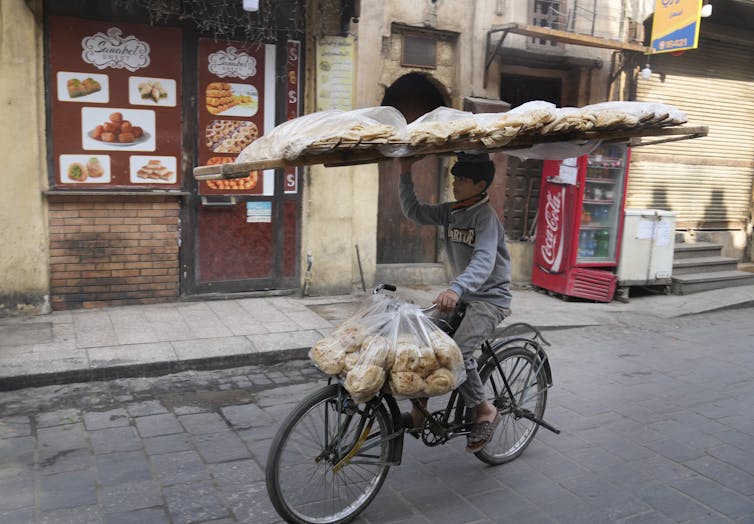 Egypt man carrying flatbread
