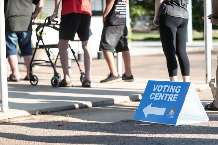 A queue of people lining up to vote in a political election