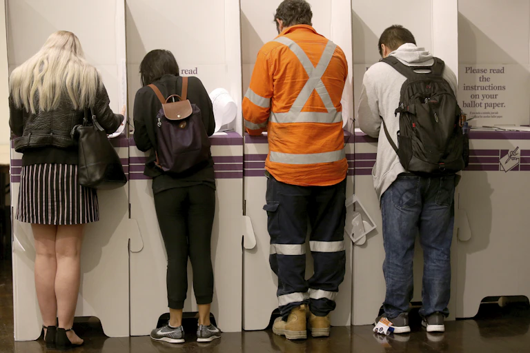 Four Australian voters at a polling booth