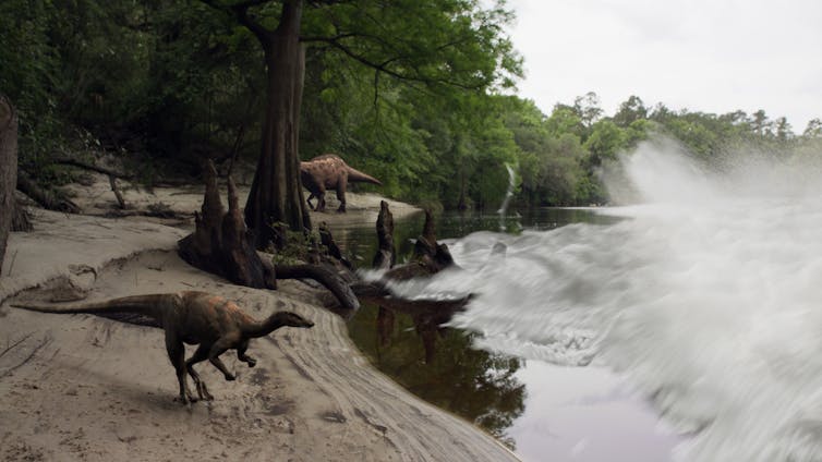 Dinosaurs by waters edge at Tanis as water crashes towards them