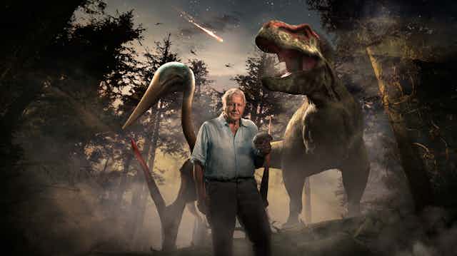 David Attenborough in front of dinosaurs