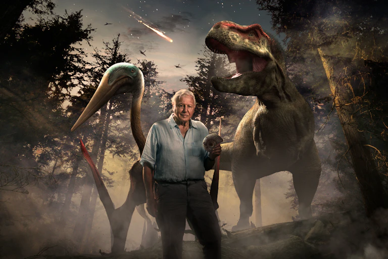 David Attenborough in front of dinosaurs