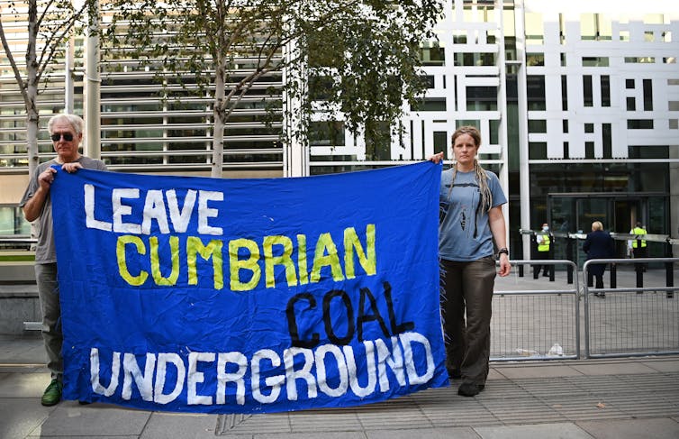Protesters with sign ‘leave cumbrian coal underground’