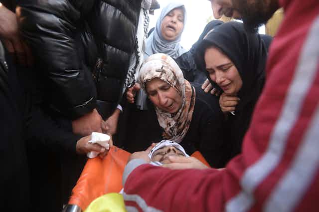 Palestinian relatives of 18 year old Lutfi Al Labadi mourn him during his funeral in the West Bank village of Al Yamoun near the city of Jenin, 22 April 2022.