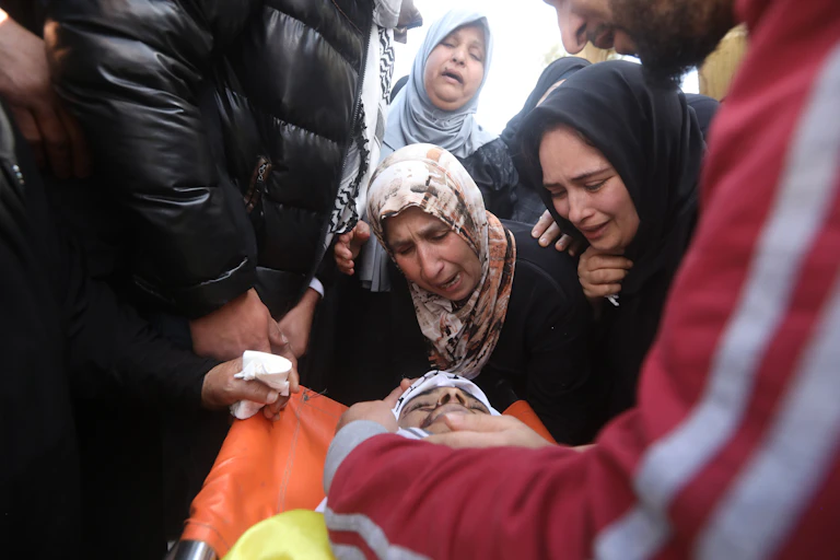 Palestinian relatives of 18 year old Lutfi Al Labadi mourn him during his funeral in the West Bank village of Al Yamoun near the city of Jenin, 22 April 2022.