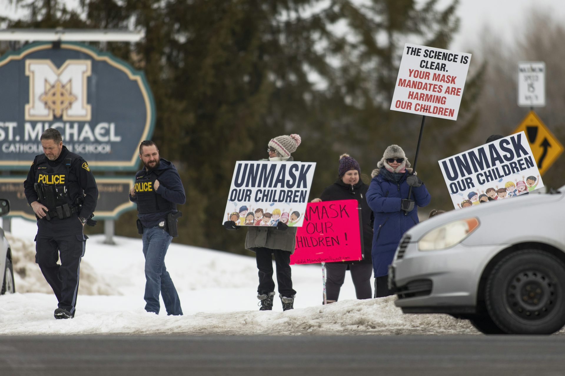 Anti-masking protesters seen outside a school.