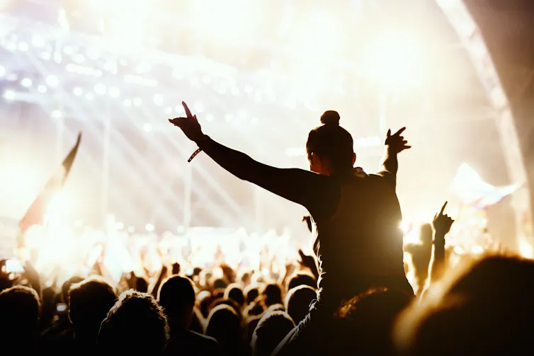 Girl on shoulders at a music festival