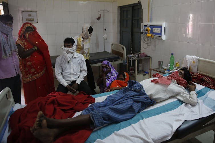Man in hospital bed in India