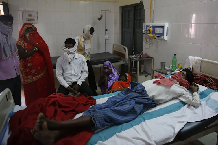 Man in hospital bed in India