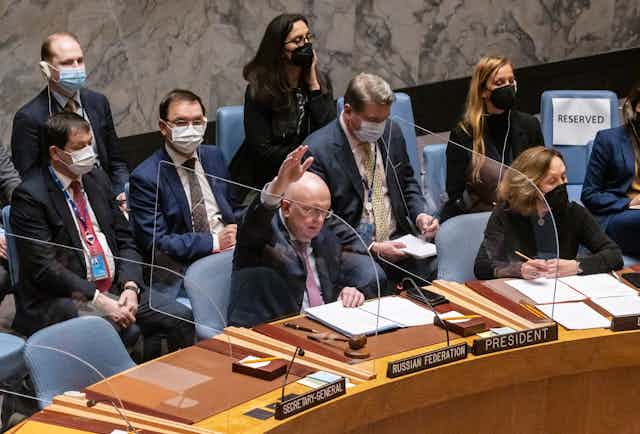 Russia’s Ambassador to UN Vassily Nebenzia raises his hand to veto a resolution dondemning Russia's invasion of Ukraine, February 25 2022.