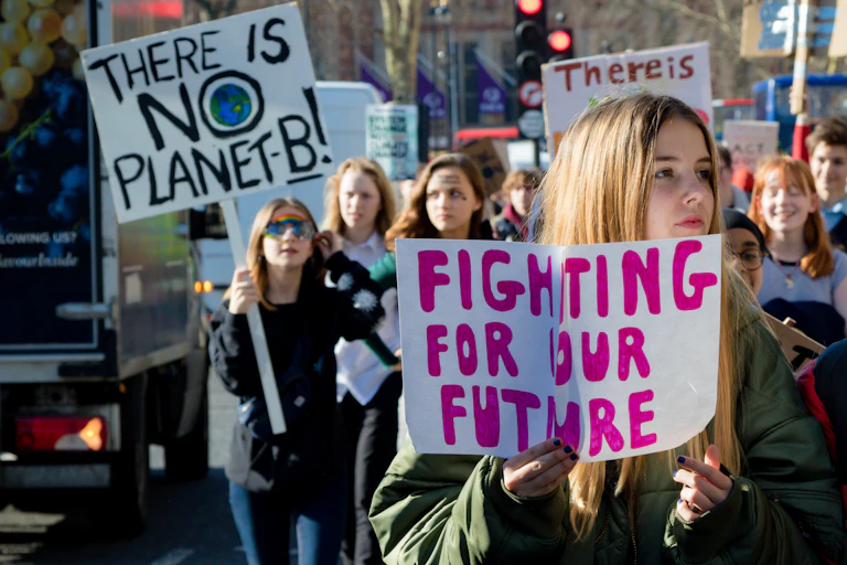 Teenagers holding environmental placards
