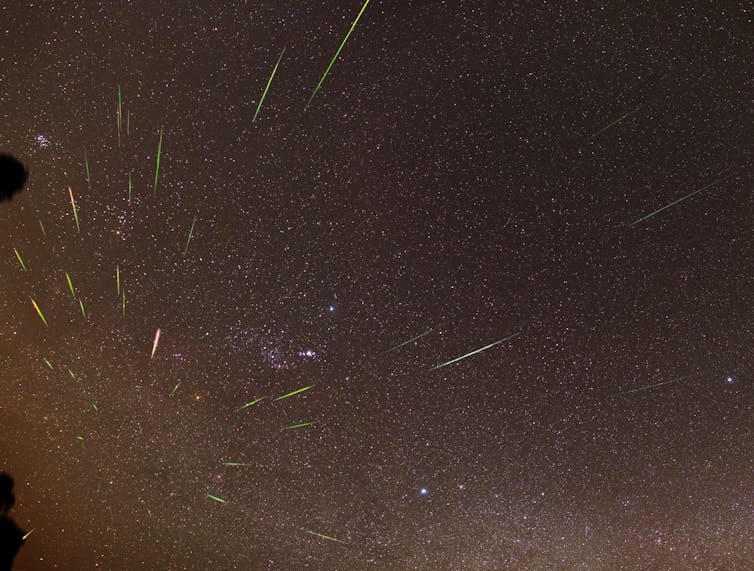 Meteors from the Orionid meteor shower in 2011, radiating from a point near the lower left of the image.