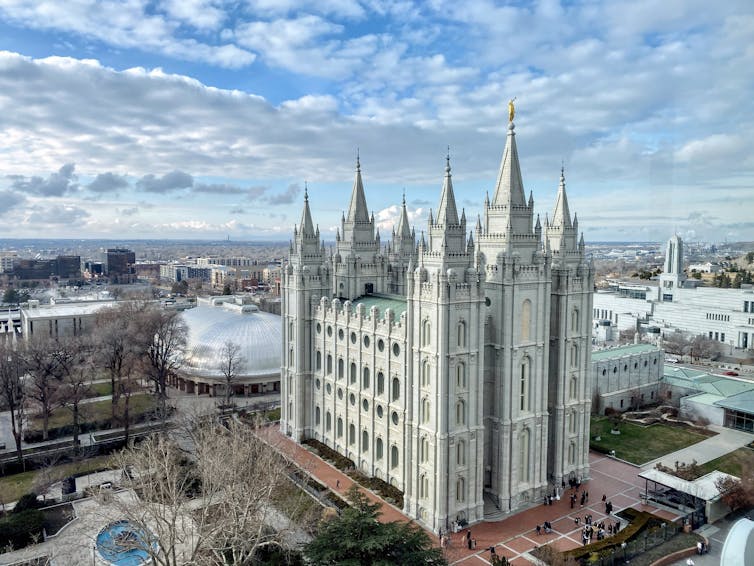 An ornate white building rises above a cityscape.