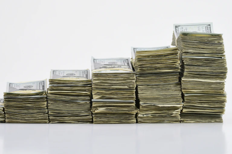 Stacks of $100 bills going from small at left to highest at right