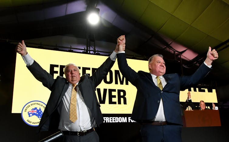 UAP leaders Clive Palmer and Craig Kelly grasping hands in a 'victory stance' at the UAP campaign launch in Queensland.