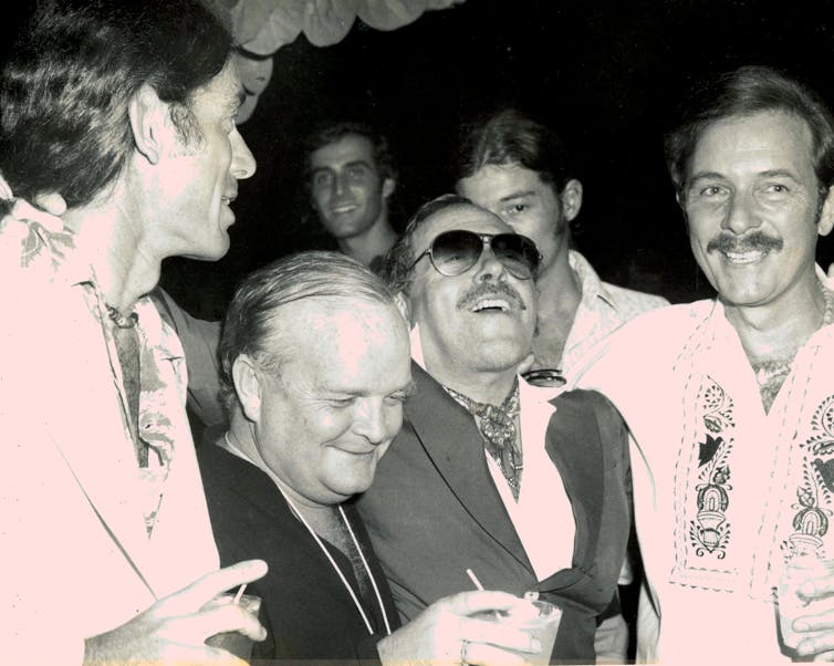 four men at a party in the 70s