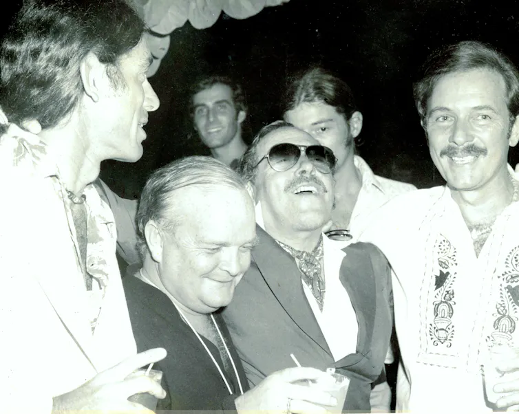 four men at a party in the 70s