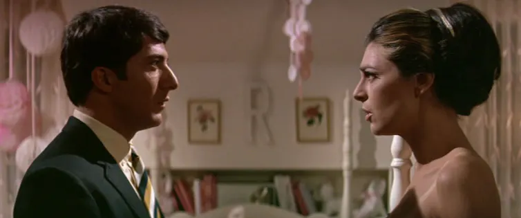 A man and woman stare at each other, balloons in background.