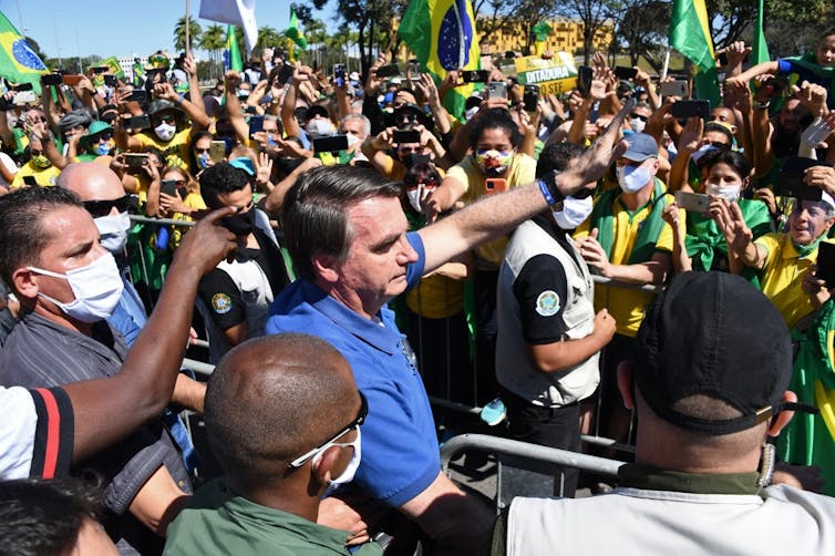 A maskless Bolsonaro wades into a crowd of supporters