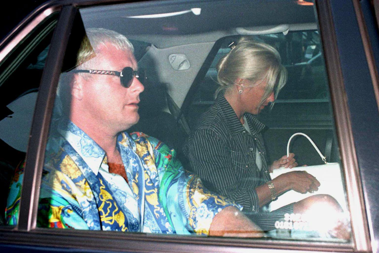 A man and a woman sit in a car.
