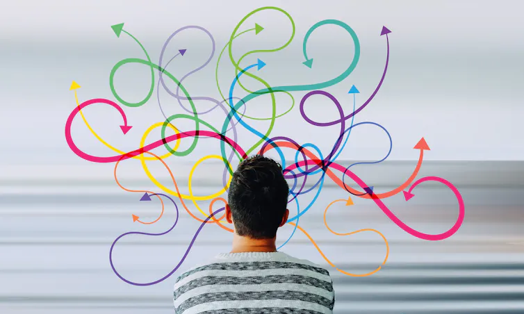 A man seen from behind with circuitous arrows in different colour pointing in different directions