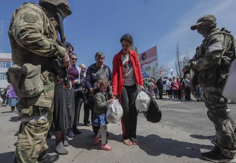 Russian servicemen and volunteers distributing humanitarian aid in the Ukranian city of Berdyansk.