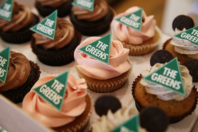 rows of cupcakes bearing Greens logo