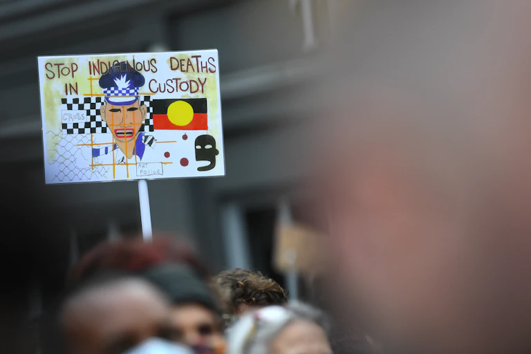 A sign at a Black Lives Matter protest reads 'Stop Indigenous Deaths in Custody'.