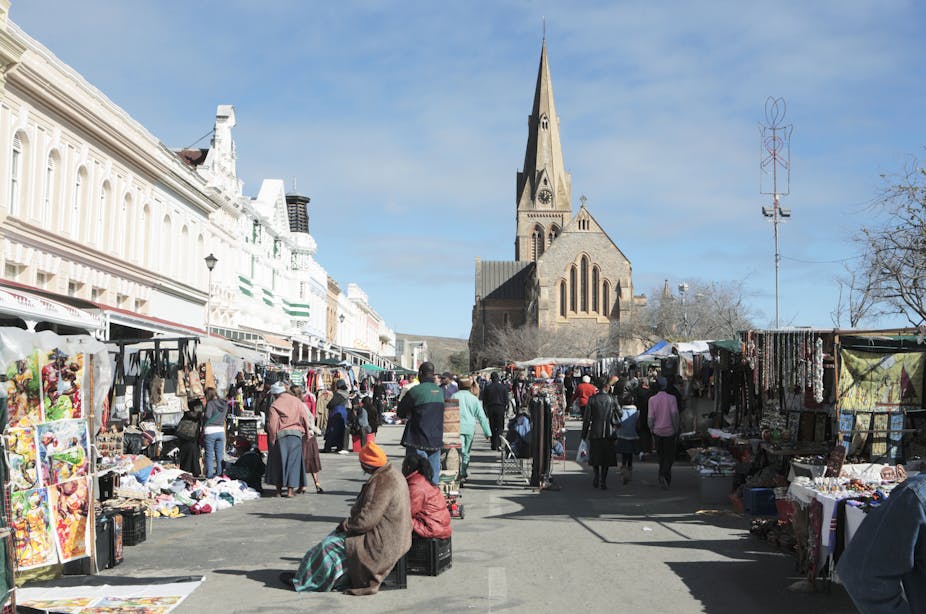 Pedestrians and traders along High Street during the National Arts Festival in Grahamstown, South Africa.