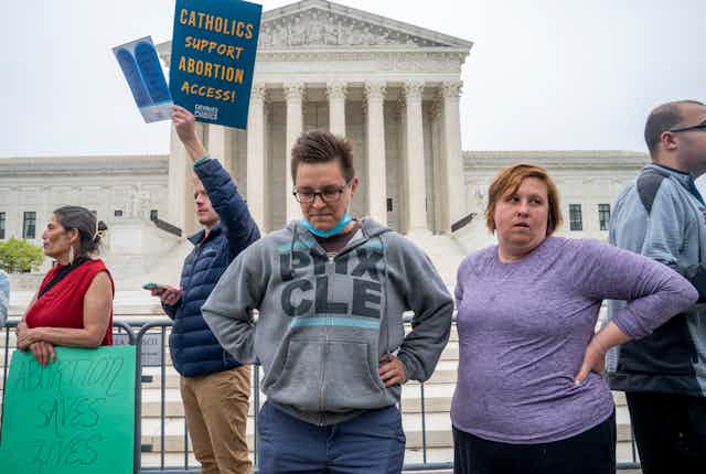 Protestors look dejected in front of the Supreme Court. 