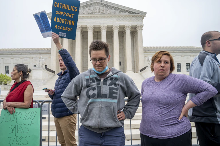 Protestors look dejected in front of the Supreme Court.
