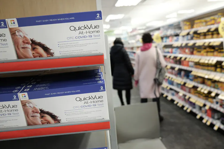 COVID-19 rapid tests for home use on a pharmacy shelf