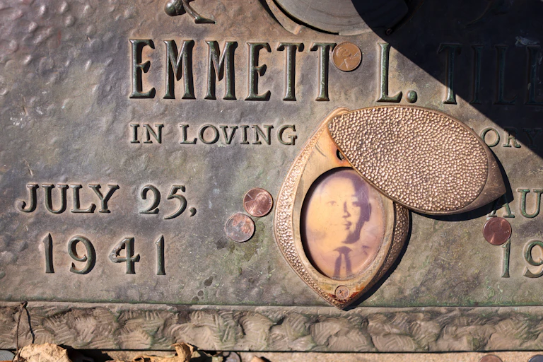 Grave stone featuring faded photograph of Black teenager.