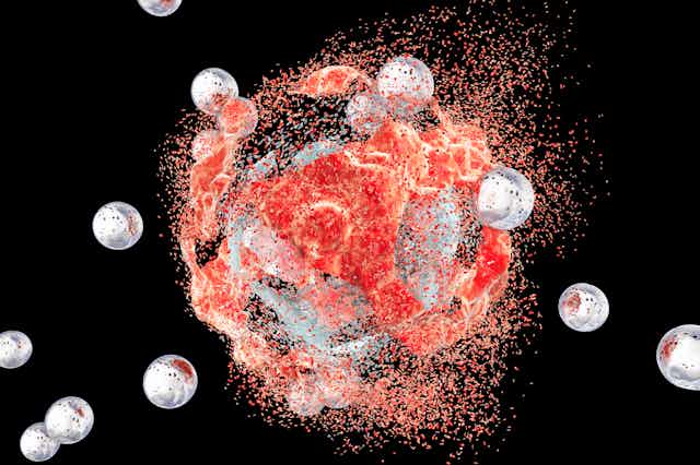 Illustration of nanoparticles bursting out of a cancer cell