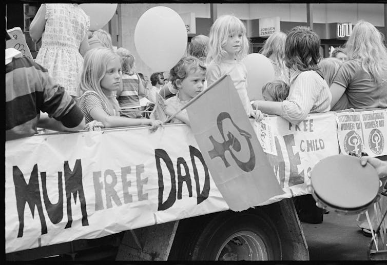 Partially obscured banner reads 'mum, free dad, child care'