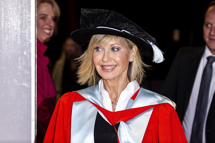 Olivia Newton John in cap and gown