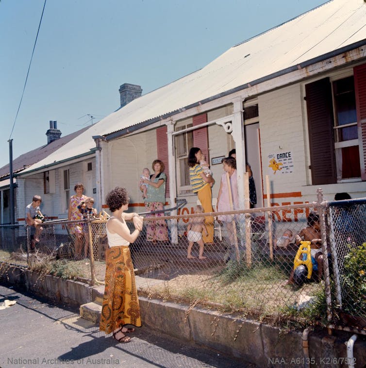 Women outside a ramshackle house