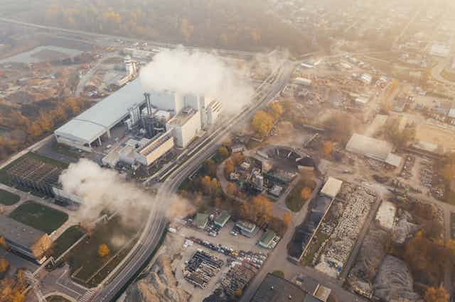 Aerial view of factory producing smoke