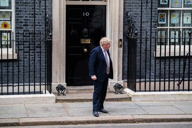 Boris Johnson is outside Downing Street.