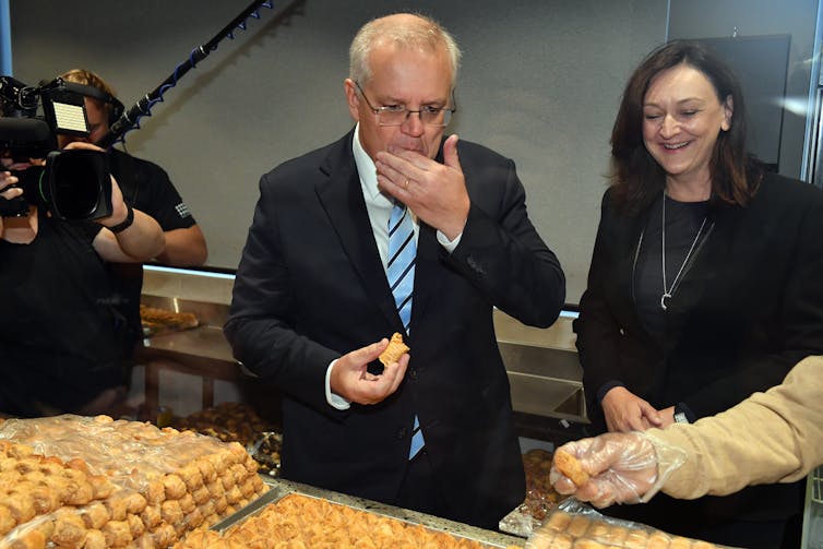 Scott Morrison tries Lebanese sweets in the electorate of Parramatta.