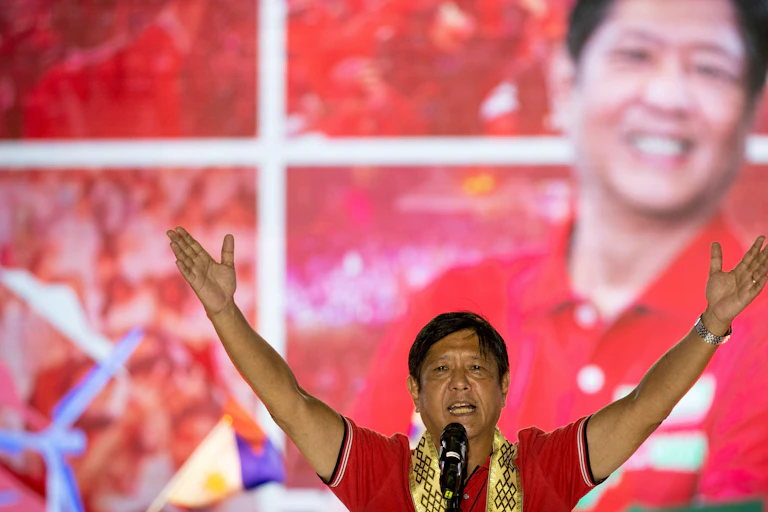 Man in red holding his arms in the air.
