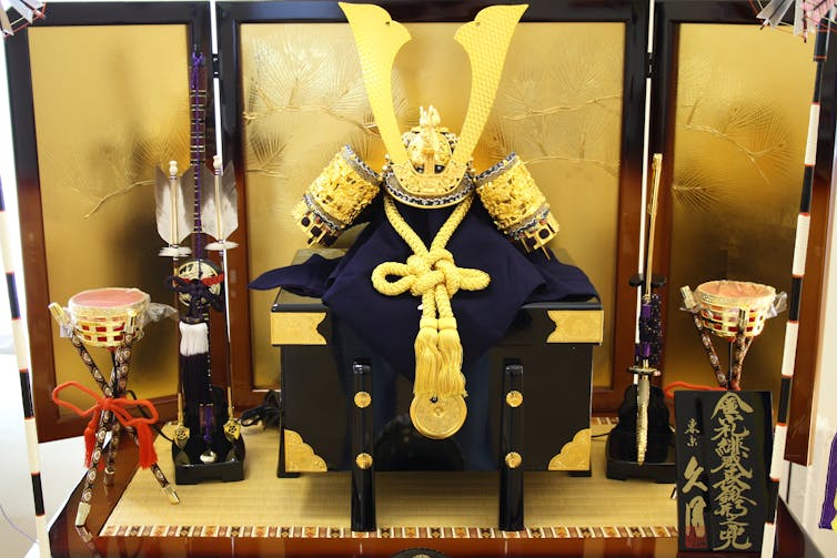 Golden helmet and other items and gold display backdrop