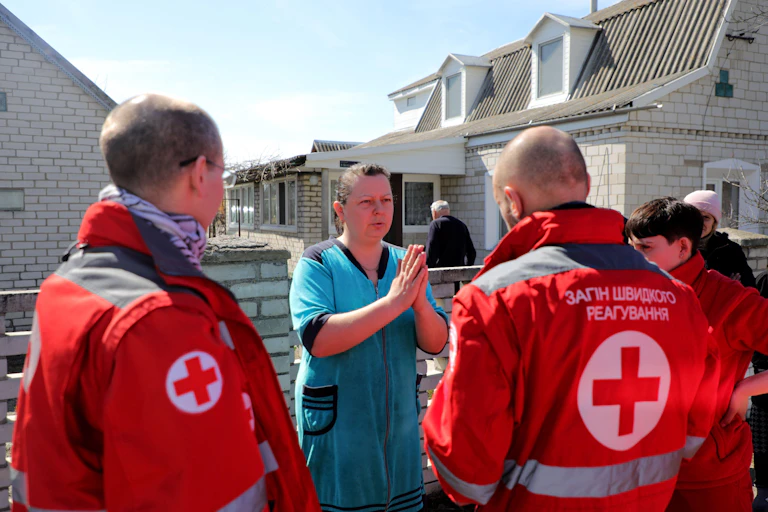 Ukrainian red cross workers with local residents at a town near Kyiv, April 2022.